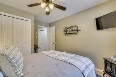 a bedroom with a bed and a ceiling fan at Newly Renovated! Peaceful Saylorsburg Home in Saylorsburg