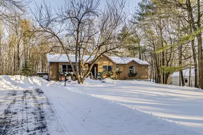 a house in the snow with a driveway at Newly Renovated! Peaceful Saylorsburg Home in Saylorsburg