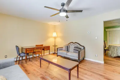 a living room with a couch and a table at Pet Friendly and WFH Ready! Quiet Hudson Valley Apt in Newburgh
