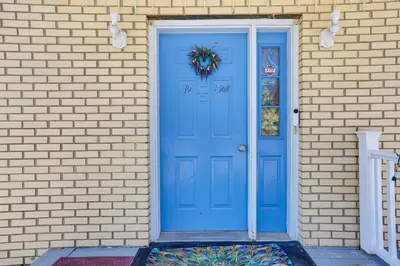 a blue door with a wreath on it on a brick wall at Pet Friendly and WFH Ready! Quiet Hudson Valley Apt in Newburgh