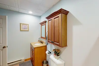 a bathroom with a sink and a toilet and a cabinet at Mountain View Memories at Northridge in Tannersville