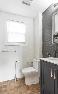a bathroom with a toilet and a sink and a window at New home, 17 min to NYC, 5 min to MetLife Stadium in Carlstadt