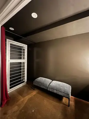 a couch sitting in a room with a window at The Vault - Hidden Playroom For Couples - Private Hot Tub - Mountain Views - Riverfront in Barryville