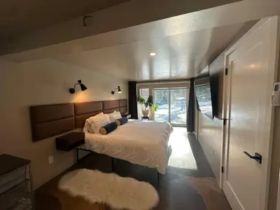 a bedroom with a bed and a large window at The Vault - Hidden Playroom For Couples - Private Hot Tub - Mountain Views - Riverfront in Barryville