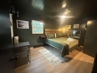 a bedroom with a green bed and a window at Gilded Cage Escapes - Hidden Playroom For Couples - Private Hot Tub - Mountain Views - Riverfront in Lackawaxen