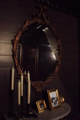 a mirror sitting on top of a table with candles at Romantic AFrame Cabin with Firepit, BBQ in Pocono Pines