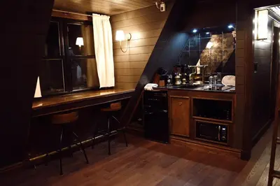 a kitchen with a counter and a bar with a sink at Romantic AFrame Cabin with Firepit, BBQ in Pocono Pines