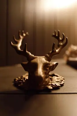 a bronze deer head with antlers sitting on a table at Romantic AFrame Cabin with Firepit, BBQ in Pocono Pines