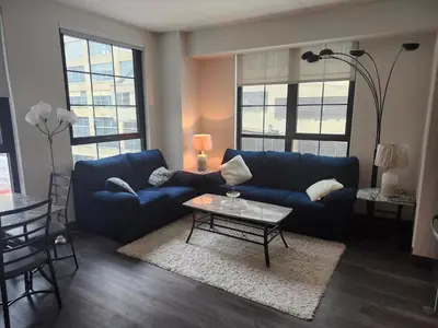 a living room with a blue couch and a table at express housing in Philadelphia