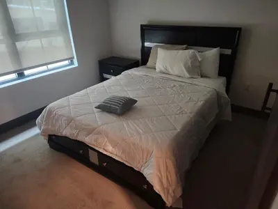 a bed with a pillow on it in a bedroom at express housing in Philadelphia