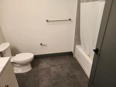 a bathroom with a toilet and a sink and a tub at express housing in Philadelphia