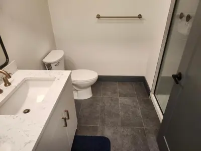 a bathroom with a toilet and a sink and a shower at express housing in Philadelphia