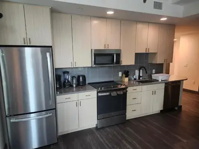 a kitchen with stainless steel appliances and wooden cabinets at express housing in Philadelphia