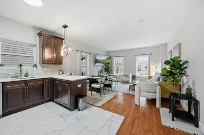 a kitchen and living room with a living room and a dining room at Sleeps 19 • 15ft Celings • Near NYC in Jersey City