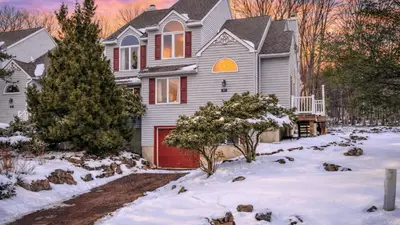a house with a red garage in the snow at Mountain Laurel Lodge by AvantStay Lake Harmony Retreat • Loft Games Ski Private Club Access in Lake Harmony