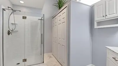 a white bathroom with a shower and white cabinets at Mountain Laurel Lodge by AvantStay Lake Harmony Retreat • Loft Games Ski Private Club Access in Lake Harmony