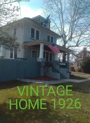 a house with a sign that reads vintage home at Oakland House Apartments in Phoenixville