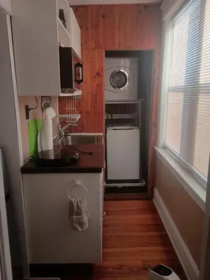 a small kitchen with a sink and a microwave at Oakland House Apartments in Phoenixville