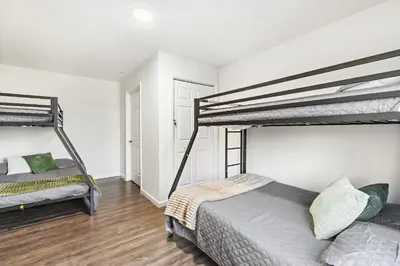 a bedroom with two bunk beds in it at Urban Haven XL - NYC & Newark with free parking in Newark