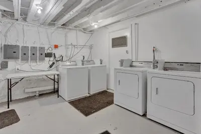 a laundry room with white appliances and a table at Renovated 2BR in Germantown in Philadelphia