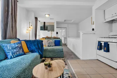 a living room with a blue couch and a table at Renovated 2BR in Germantown in Philadelphia