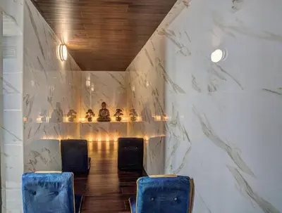 two blue chairs in a room with marble walls at The Luxe Lodge Escape in Tannersville