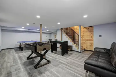 a living room with a ping pong table and a couch at The Luxe Lodge Escape in Tannersville