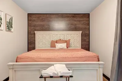 a bedroom with a large bed with a wooden headboard at The Luxe Lodge Escape in Tannersville