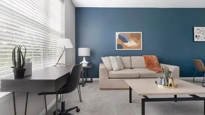 a living room with blue walls and a couch at Landing Amazing 1BD Gym Game Room in Bayonne