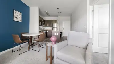 a living room with a couch and a table at Landing Amazing 1BD Gym Game Room in Bayonne