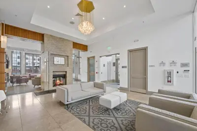 a living room with a couch and a fireplace at Landing Amazing 1BD Gym Game Room in Bayonne