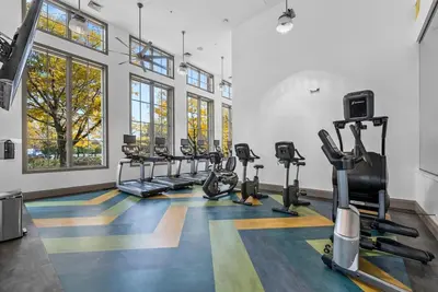 a gym with treadmills and cardio machines in a room at Landing Amazing 1BD Gym Game Room in Bayonne