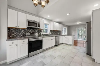 a kitchen with white cabinets and a stove top oven at Pocono Pride in East Stroudsburg