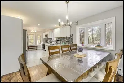 a dining room and kitchen with a table and chairs at Pocono Pride in East Stroudsburg