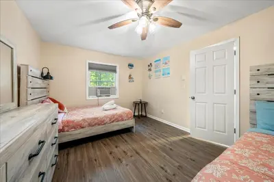 a bedroom with two beds and a ceiling fan at Pocono Pride in East Stroudsburg