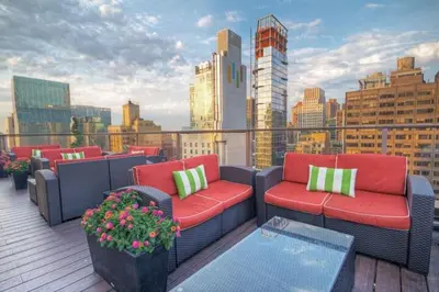 a balcony with couches and a view of a city at Club Wyndham Midtown 45 in New York