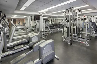 a gym with a lot of equipment in a room at Club Wyndham Midtown 45 in New York