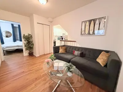 a living room with a couch and a glass table at New York Central Park Suites in New York