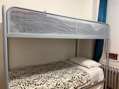 a bunk bed in a small room with a bunk bedsheet at New York Central Park Suites in New York