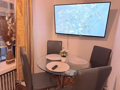 a dining room with a glass table and chairs at New York Central Park Suites in New York