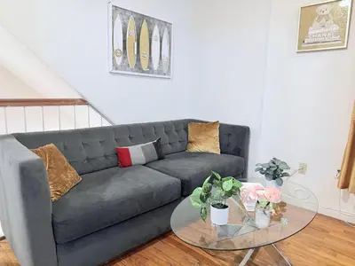 a living room with a couch and a glass table at New York Central Park Suites in New York