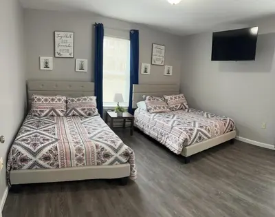 a bedroom with two beds and a flat screen tv at Home in Poconos in Albrightsville