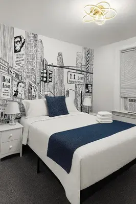 a bedroom with a large bed with a drawing of a city at Renovated 3BR - Near Times Square - Family Groups in West New York