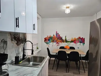 a kitchen with a table and chairs in a kitchen at Renovated 3BR - Near Times Square - Family Groups in West New York