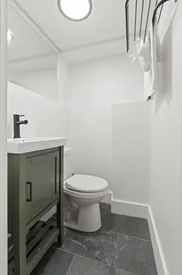 a white bathroom with a toilet and a sink at Oasis Spacious-Private Parking 16 Beds 29 Guests in Philadelphia