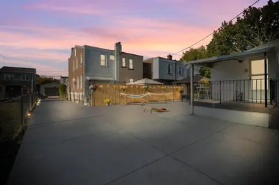 a patio with a fence and some houses at Oasis Spacious-Private Parking 16 Beds 29 Guests in Philadelphia