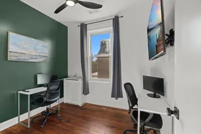 an office with two desks and chairs and a window at Oasis Spacious-Private Parking 16 Beds 29 Guests in Philadelphia
