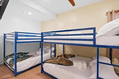 two bunk beds in a room with white walls at Summit Stay Near Kalahari & Raceway in Pocono Summit
