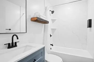 a white bathroom with a sink and a toilet at Summit Stay Near Kalahari & Raceway in Pocono Summit