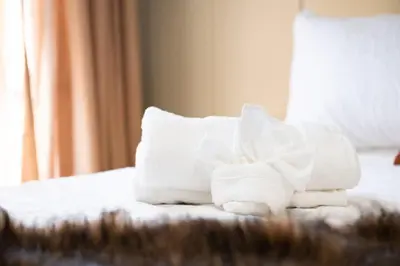 a pile of towels sitting on top of a bed at Summit Haus Cozy Getaway in the Poconos in Pocono Summit